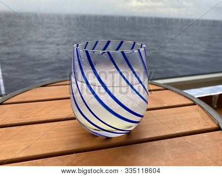 An Alcoholic Beverage Of Vodka And Lemonade On A Table Aboard A Cruise Ship Balcony Overlooking The 