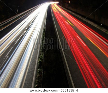 Interrupted Strips Of Light Due To A Bridge Railing