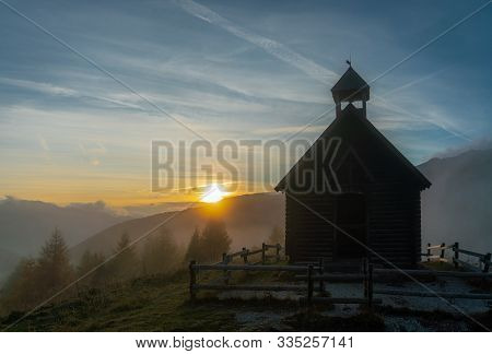 Sunset On A Foggy Evening Overlooking The Valley And The Chiesetta Alpina Chappel At The Valles Pass