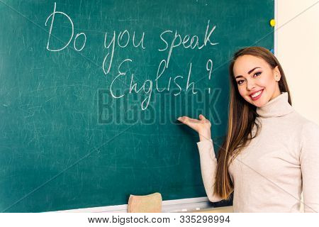 Portrait Of Pretty Cute Student Near Blackboard.english Leson. Education And School Concept.