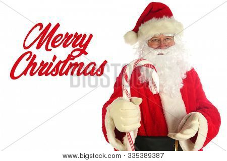 Santa Claus. Christmas Santa. Isolated on white. Room for text. Santa Claus holds a Giant Candy Cane. Peppermint Red and White Striped Candy Canes are popular at Christmas. Merry Christmas text. 
