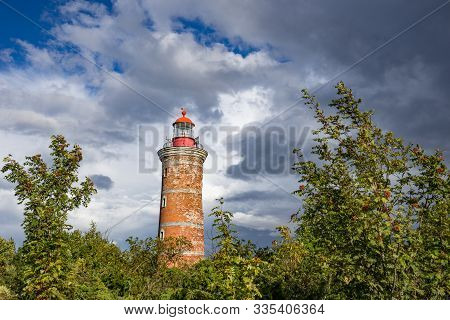 Lighthouse And House In The Baltic Sea. Shore, Evening Light, Sunset, Clouds And Architecture Concep