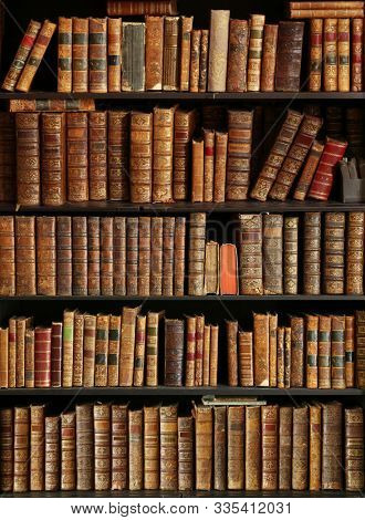 antique books on bookshelf in a library