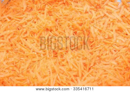 Background Grated Carrots. Carrots Close-up. Finely Grated Carrots. Texture Of Carrots.