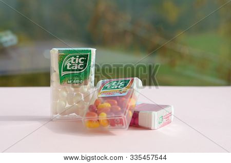 Many Tic Tac Candy Packages On Green Wood Background. Tic Tac Is Popular Due Its Minty Fresh Taste A