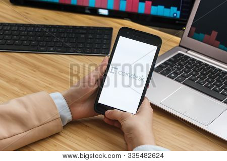 Coindesk Cryptocurrency Exchange Market. Female Trader Hands Holding The Smartphone Using Applicatio