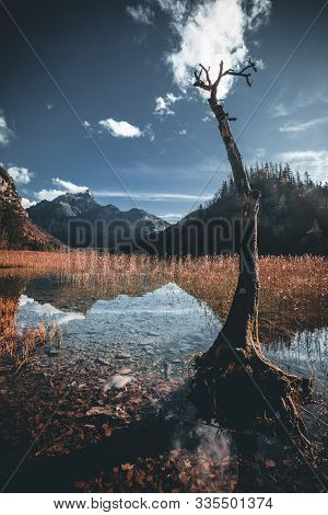 Mountain And Lake Landscape With Reflection During Autumn At The Leopoldsteiner See