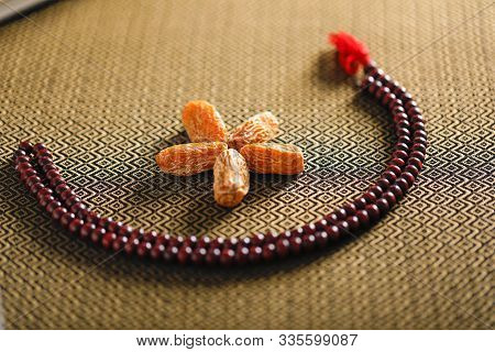 Date Fruits With An Islamic Prayer Beads On An Artistic Background. Beautiful Background For Ramzan 