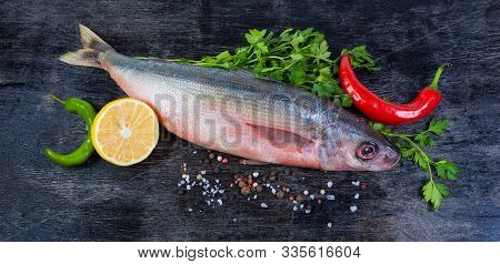 Single Carcass Of Raw Redbait Fish, Also Known As Bonnetmouth Or Emmelichthys Nitidus, Parsley, Chil