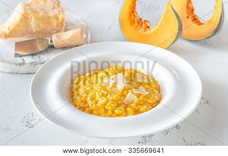 Portion Of Pumpkin Risotto With Slices Of Parmesan