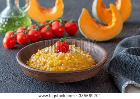 Portion Of Pumpkin Risotto Decorated With Cherry Tomato