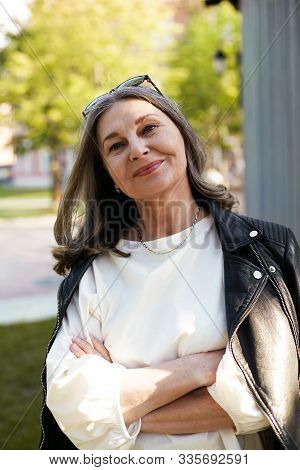 Cheerful Beautiful Mature Woman In Her Fifty Enjoying The Nice Summer Weather Outdoors In The Park, 