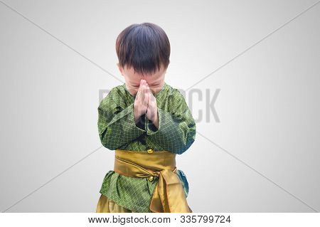 Asian Little Toddler Boy In Thai Vintage Costume Greeting Isolated On White Gradient Background With