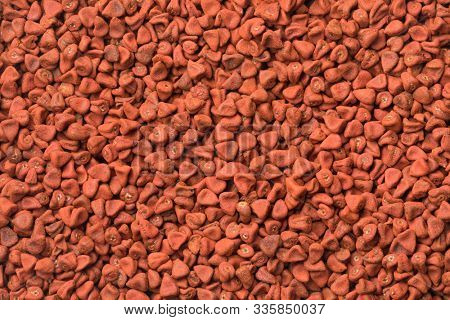 Dried Annatto seeds close up full frame