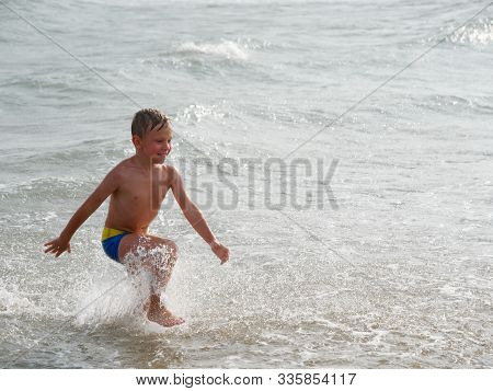 Children Swim In The Sea On The Beach In Bibione, Italy