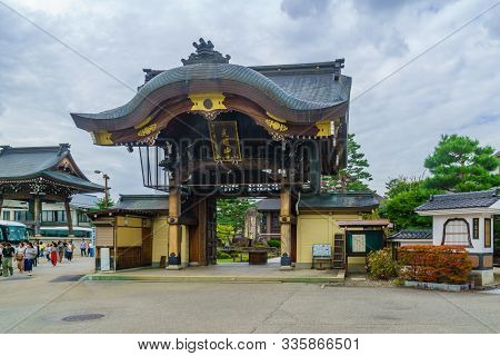 Takayama, Japan - October 2, 2019: View Of The Gate Of The Shinshuotaniha Shoren Temple, With Locals