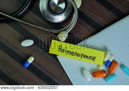 Perimenopause Write On Sticky Notes Isolated On Wooden Table.