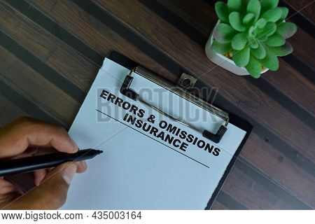 Errors & Omissions Insurance Write On A Paperwork Isolated On Wooden Table.
