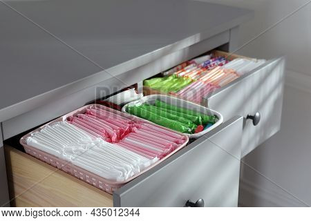 Open Cabinet Drawers With Menstrual Pads, Tampons And Pantyliners Indoors, Closeup