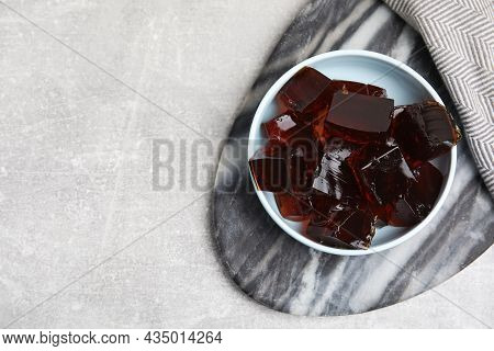 Delicious Grass Jelly Cubes On Light Grey Table, Top View. Space For Text
