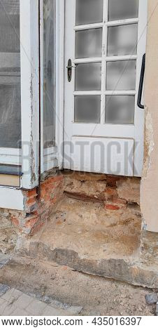 Vertical Close Up Entrance To House Without Porch, Steps Removed.old House, Need For Renovation Conc