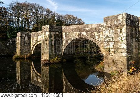 Brandomil Roman Stone Bridge Reflected On The Water In Zas, A Coruña, Spain