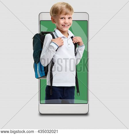 Young Smiling Schoolboy Using Modile Application For Remote Study Concept