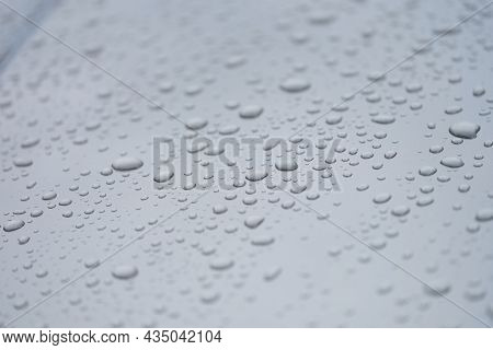 Closeup Of Drops On Dark Glass Car Background