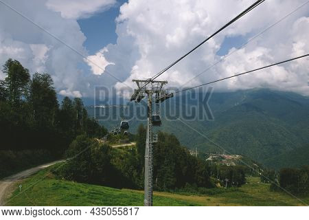 Cable Car In The Mountains With Clouds. View From The Cable Car To The Mountain Landscape. The Cable