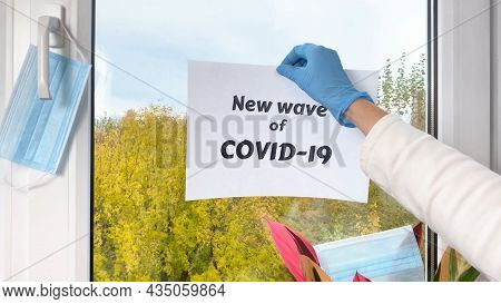 Doctor's Hand Put Sheet Of Paper With Word New Wave Of Covid-19 At Window. Covid 19 Coronavirus Pand
