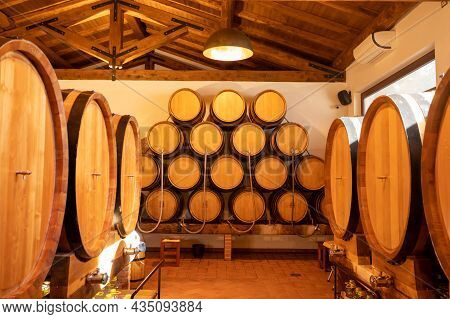 White, Rose And Red Wine In Barrels For Sale In Wine Cellars In Italy
