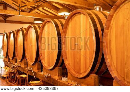 White, Rose And Red Wine In Barrels For Sale In Wine Cellars In Italy