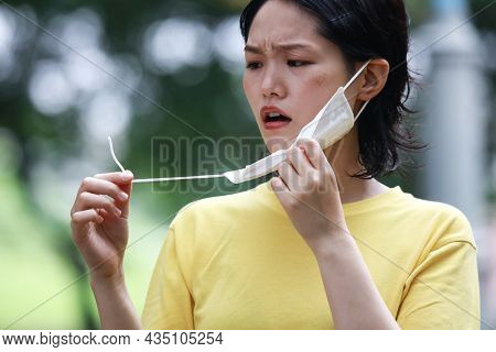 Image Of A Woman With A Broken Mask
