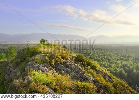 A Blooming Mountainside In The Morning Light Under A Blue Cloudy Sky In The Altai Mountains. Siberia