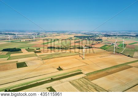 Windmill Among Agricultural Fields. Wind Turbine Generator At Summer Day. Wind Energy Concept. Suist