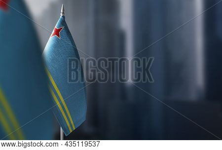 Small Flags Of Aruba On A Blurry Background Of The City