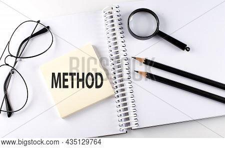 Word Method On The Sicker On The Notebook With Pencils,magnifier And Glasses
