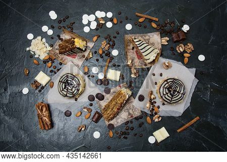 Lots Of Pastries And Cakes, Chocolate, Frosting And Cinnamon Top View On A Dark Background, Copy Spa