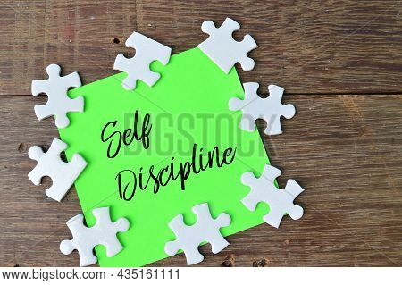 Jigsaw Puzzle And Memo Note Written With Text Self Discipline