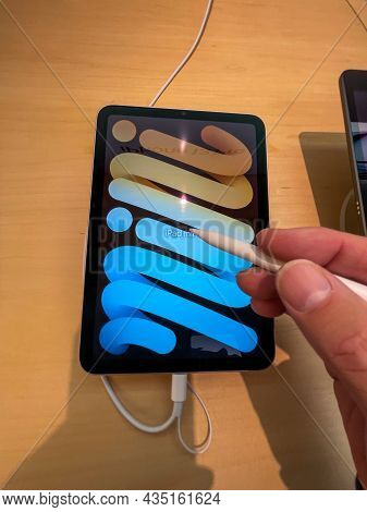 Cologne, Germany - September 30th 2021: A German Photographer Visiting An Apple Store, Comparing Tth