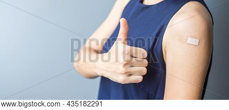 Happy Woman Showing Thumb With Bandage After Receiving Covid 19 Vaccine. Vaccination, Herd Immunity,