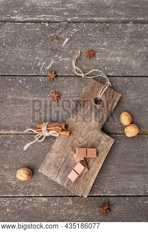 Pieces Of Chocolate, Cinnamon Sticks And Star Anise On A Wooden Board, Photo Rusticstyle