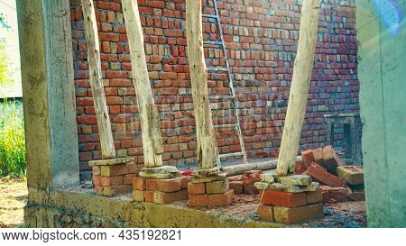 Red Bricks And The Unconstructed Wall Of High Quality Construction Material. Under Construction Site