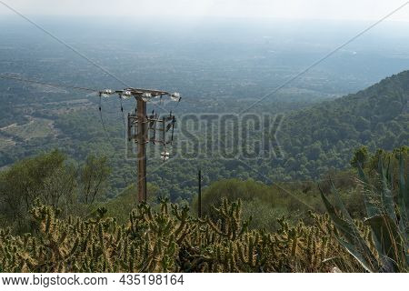 Mountainous Mediterranean Landscape At Sunset On The Island Of Mallorca, With An Electric Light Pole