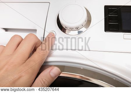 Female Hand Pushing Start Stop Button Of Washer, Washing Machine Cycle Interraption Or Starting, Beg