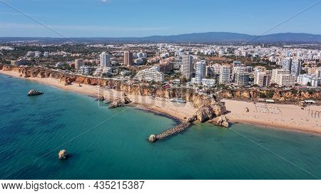 Aerial View Of The Wide And Crowded Portuguese Famous Rocha Beach In Portimao, Algarve, Portugal. Dr