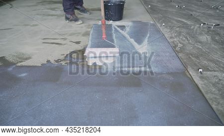 Priming The Floor With A Roller. Priming Concrete Floor Before Laying Tiles On It, The Final Prepara