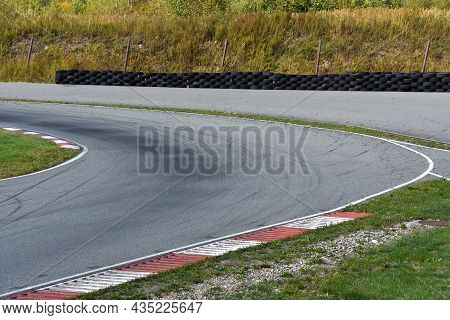 Shot Of Empty Auto Racing Racetrack Turn. Motor Racing Track. Turning Asphalt Road With Marking Line