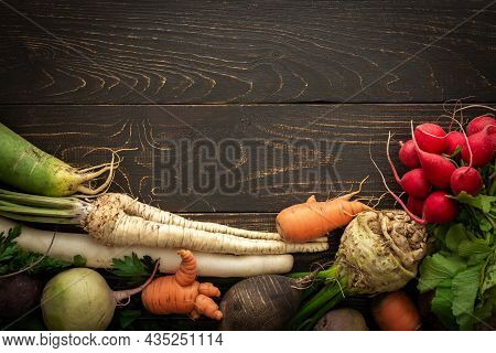 Root Vegetables On A Wooden Background