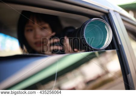 Woman Taking Pictures From Inside The Car